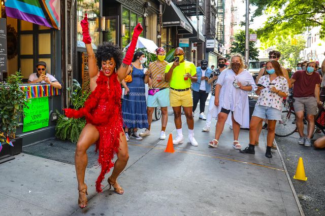 A drag show taking place on a sidewalk